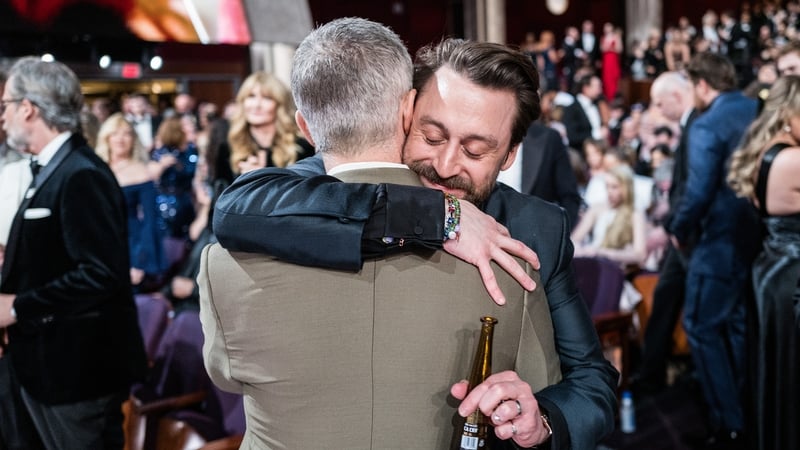 Succession stars Jeremy Strong and Kieran Culkin embrace at the 2025 Oscars