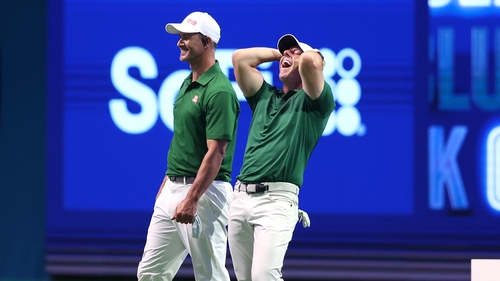 Rory McIlroy and Adam Scott in action on Monday evening