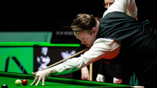 Shaun Murphy plays a shot in the first round match against Ben Woollaston
