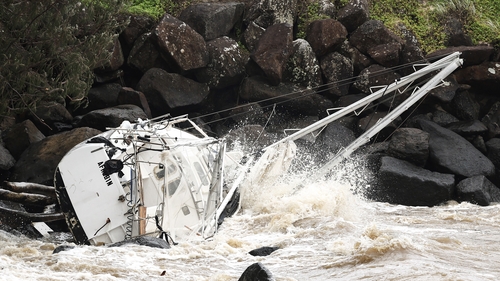 A damaged yacht is seen at Point Danger on the southern end of the Gold Coast
