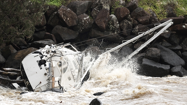 A damaged yacht is seen at Point Danger on the southern end of the Gold Coast