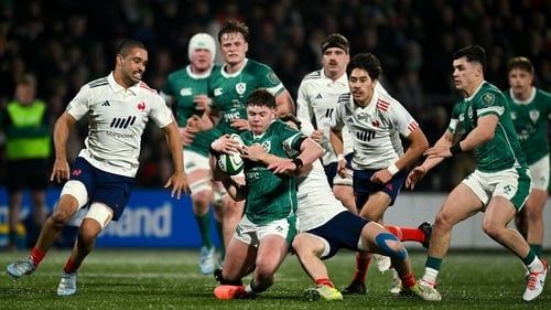 Eoghan Smyth of Ireland is tackled by Baptiste Tilloles of France