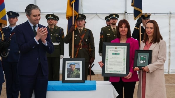 Simon Harris presented Private Kedian's sisters Ann and Mary with the Distinguished Service Medal in Private Kedian's honour