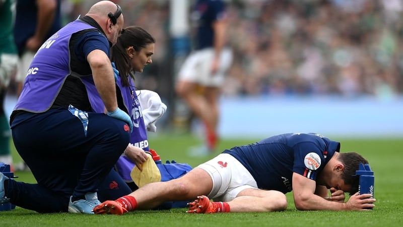 Antoine Dupont lies stricken on the turf at Aviva Stadium