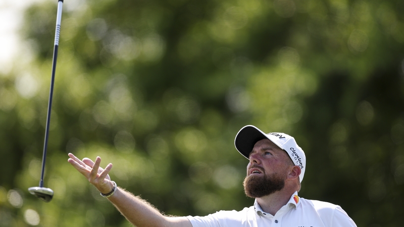 Shane Lowry tosses his club after hitting a tee shot on the first hole