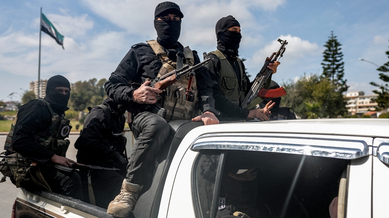Security forces loyal to the interim Syrian government are seen in Latakia