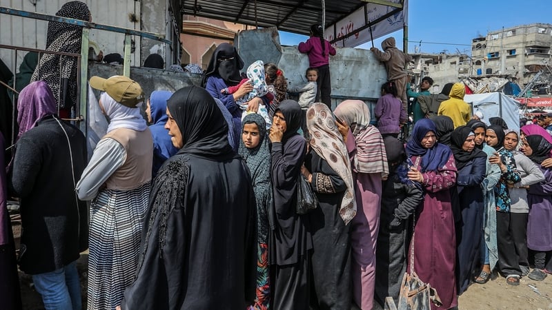 Palestinians queue for food and other supplies in Khan Younis