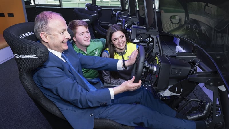 Taoiseach Micheál Martin with Kayls Cole, Formula 1000 racing driver and Daire McCormack, professional esports driver on Logitech Pro Racing SIMs.