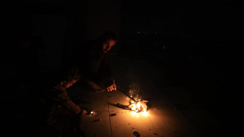 Palestinians continue to live their daily lives under difficult conditions in dark streets as electricity cuts continue in Gaza City