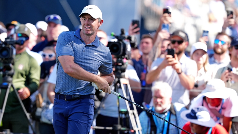 Rory McIlroy tees off on the ninth hole