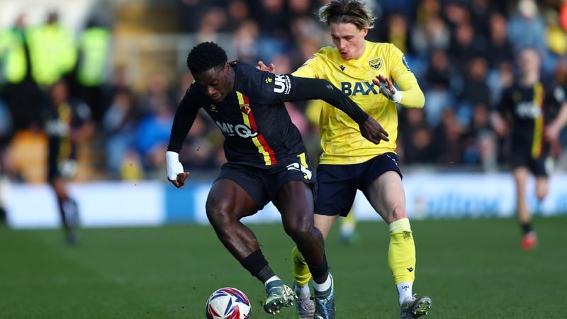 James Abankwah of Watford (L) holds off Oxford's Przemyslaw Placheta