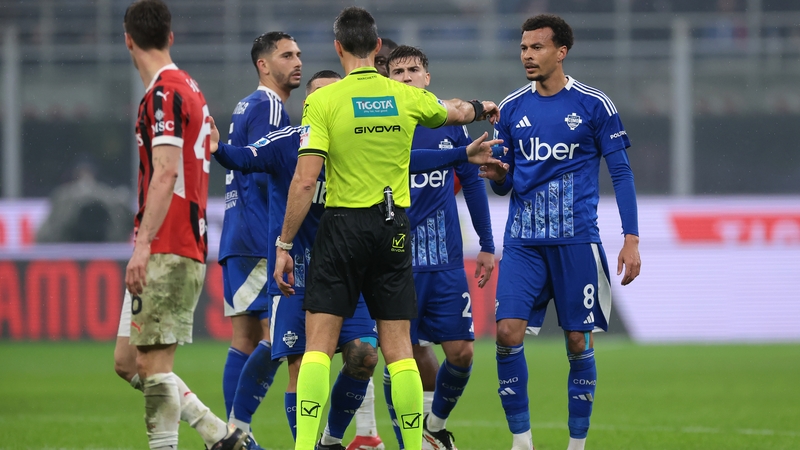 Referee Matteo Marchetti sending off Dele Alli (R) of Como 1907