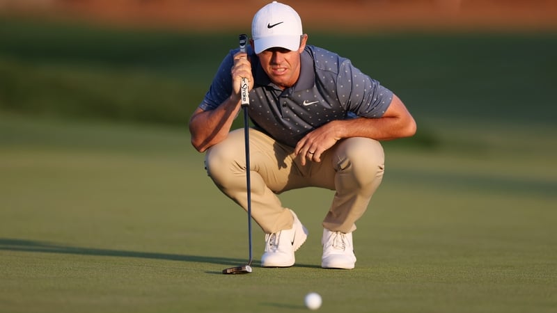 Rory McIlroy lines up a putt on the 18th green