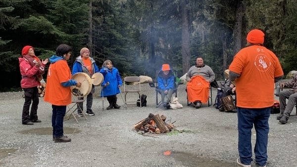 People from Lil'wat Nation indigenous community hand drumming at a ceremony