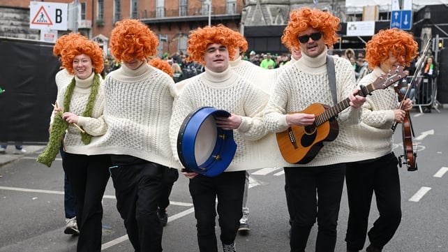 A group of parade attendees don a fused arran jumper and wigs for Dublin's St Patrick's Day parade