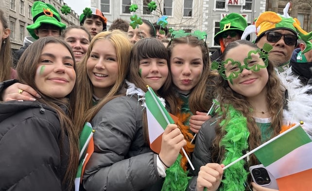 Spanish students attempting to stay warm at the capital's St Patrick's Day parade