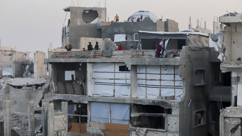 People stand on rooftops among the ruins in Beit Lahia, Northern Gaza (File image)