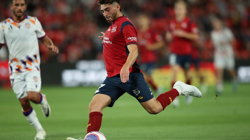 Josh Cavallo (C) in action for Adelaide United last year
