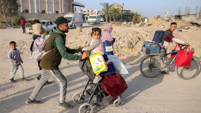 Displaced Palestinian people flee from Israeli airstrikes on northern Gaza with their belongings