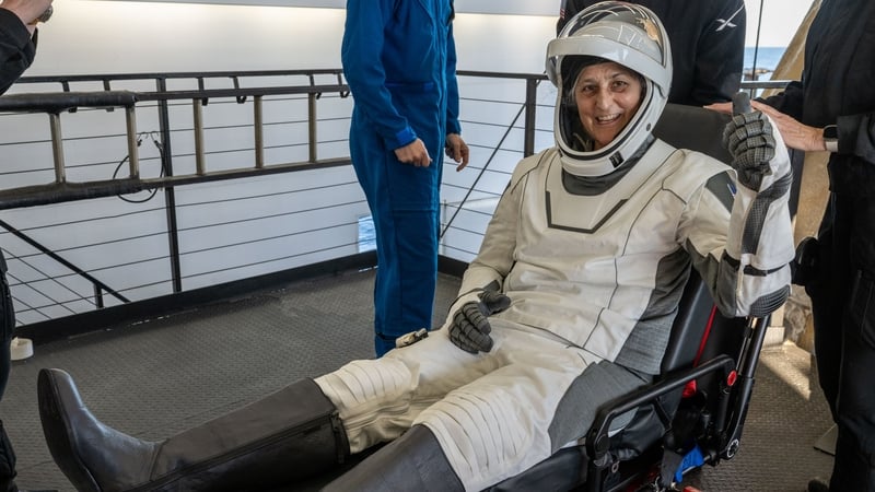 Suni Williams waves as she emerges from the SpaceX Dragon spacecraft