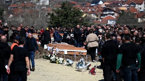 Family and friends gather during funerals for the victims of the nightclub fire in eastern North Macedonia
