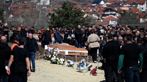 Family and friends gather during funerals for the victims of the nightclub fire in eastern North Macedonia
