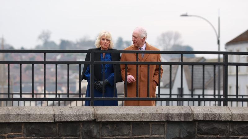 Britain's King Charles and Queen Camilla on the Rathfriland Street bridge as they look over Bridge Street in Banbridge