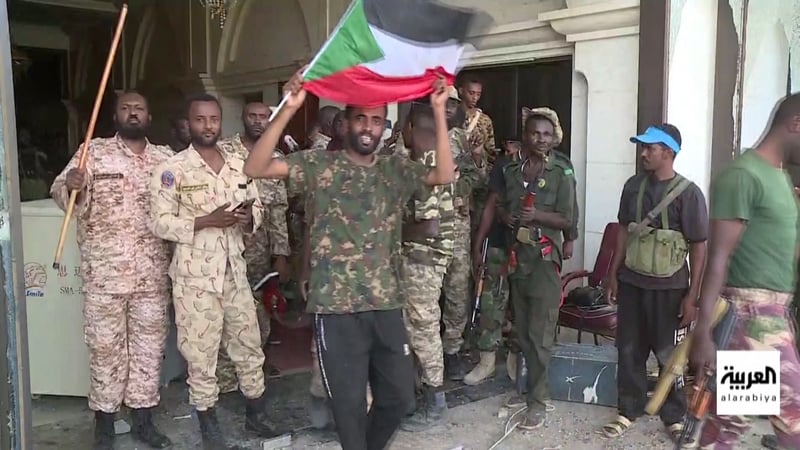 In video footage broadcast by state television, fighters who had taken up arms alongside the army waved flags in the presidential palace (Credit: AFP/AL-ARABIYA)
