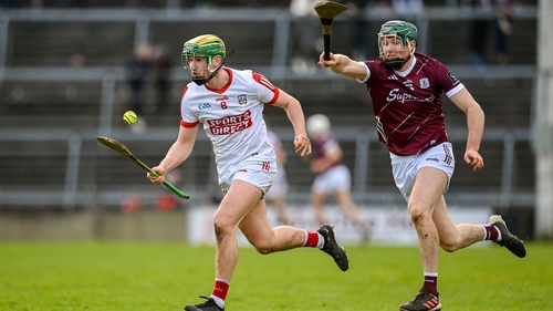 Galway's Cathal Mannion (R) pursues Brian Roche of Cork in the counties last meeting in February 2023