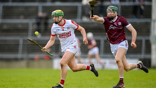 Galway's Cathal Mannion (R) pursues Brian Roche of Cork in the counties last meeting in February 2023