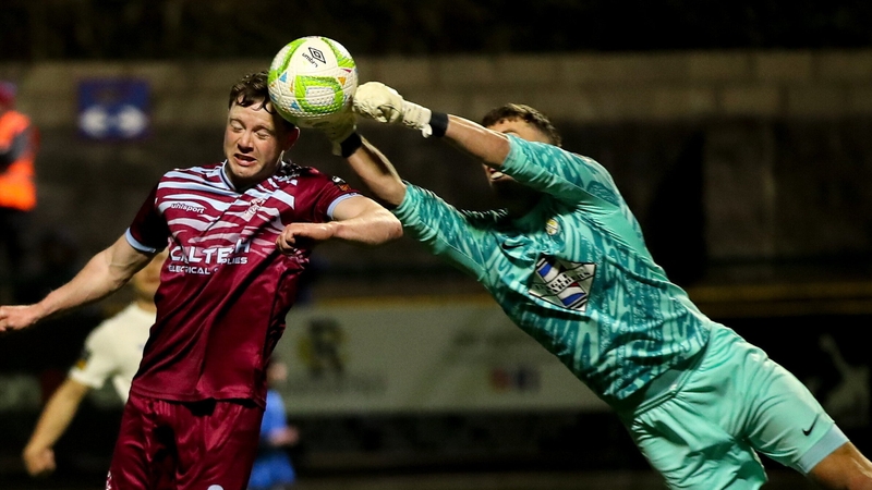 Athlone Town goalkeeper Matthew Connor fists away from Cian Murphy of Cobh Ramblers