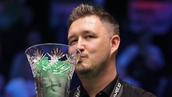 Kyren Wilson kisses the Players Championship trophy after defeating Judd Trump