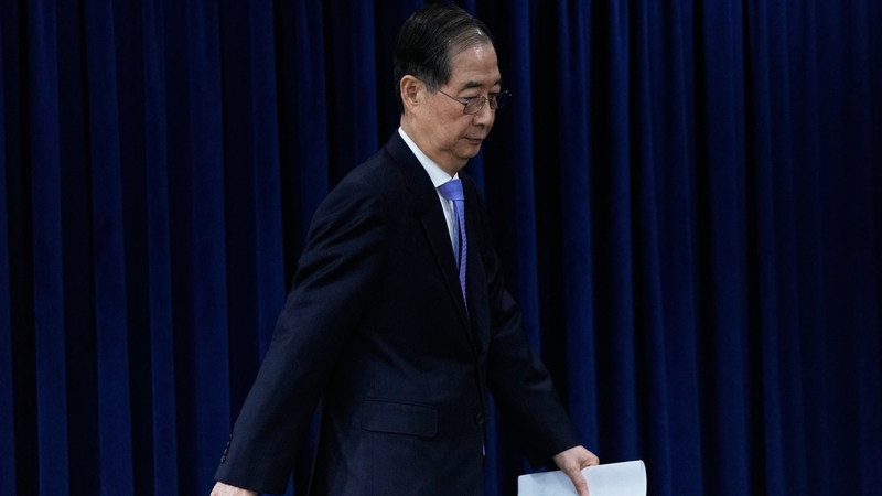 South Korea's acting President Han Duck-soo arrives to hold a briefing at the Government Complex in Seoul
