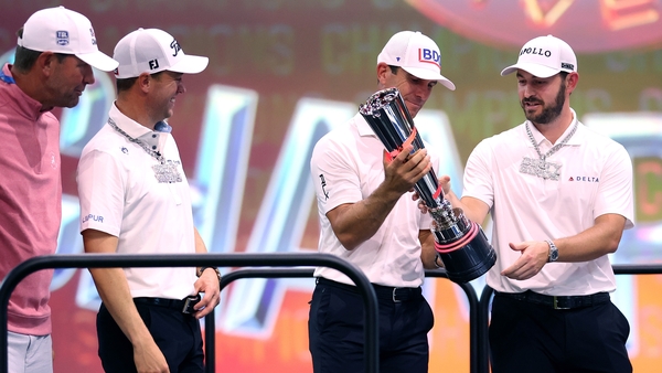 Billy Horschel and Patrick Cantlay with the trophy, alongside teammates Justin Thomas and Lucas Glover