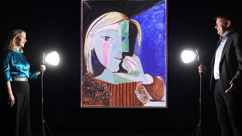 NGI Director Dr Caroline Campbell, and Seamus Hand of KPMG Ireland with a projection of Picasso's Portrait de Marie-Therese (Portrait de Marie-Therese (1934), © Succession Picasso/DACS, London 2024, © GrandPalaisRmn (musée national Picasso-Paris)