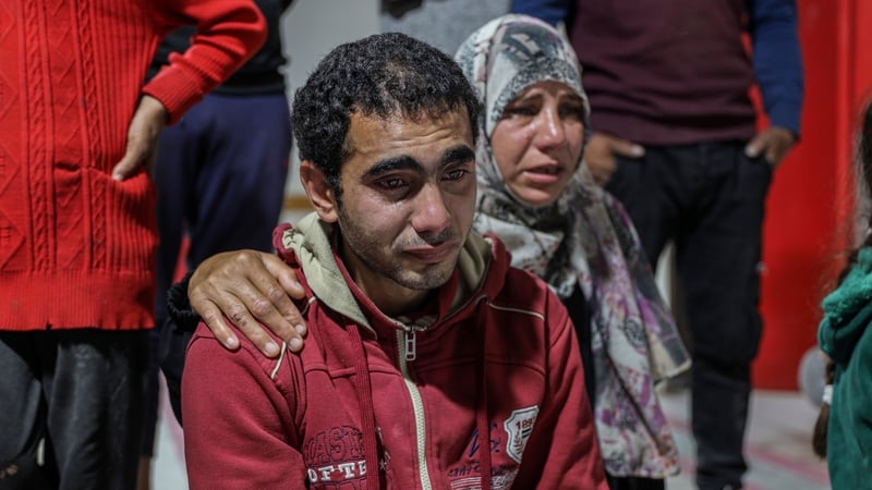 Relatives of Palestinians who lost their lives following the Israeli attack on a house, mourn as bodies are brought to hospital