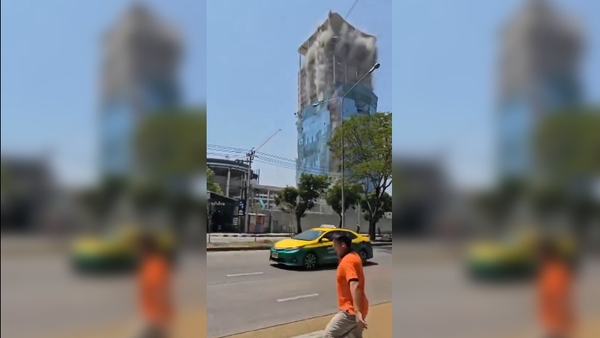 At least one person was killed and dozens of workers were rescued from under the rubble of the skyscraper,