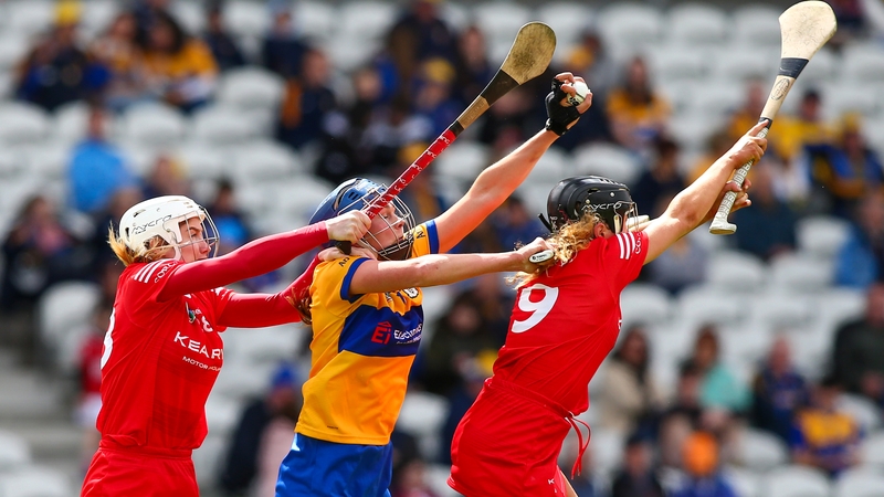 Áine O'Loughlin gathers the sliotar despite the best efforts of two Cork players