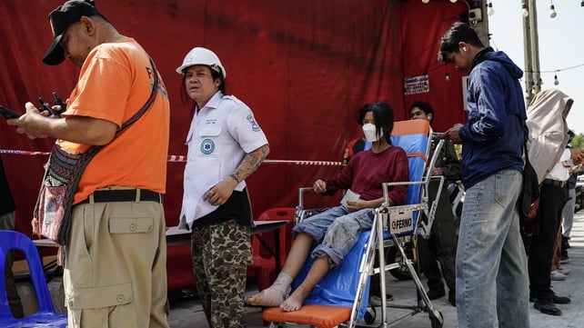 The injured are evacuated from a collapsed building in Bangkok