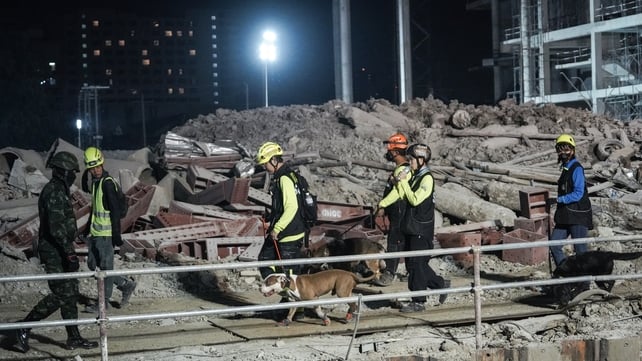 Rescue workers search for survivors at the site of a collapsed building in Bangkok