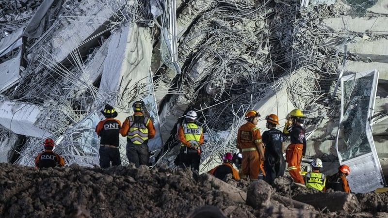 Rescue workers at the scene of the collapsed skyscraper in April