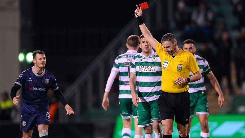 Derry City's Danny Mullen (L) is sent off by referee Paul McLaughlin