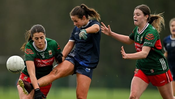 Waterford's Áine O'Neill gets her kick away under pressure from Erin Murray (L) and Sinead Walsh