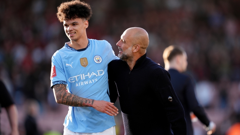 Manchester City manager Pep Guardiola (R) with Nico O'Reilly after Manchester City's FA Cup quarter-final win at the Vitality Stadium