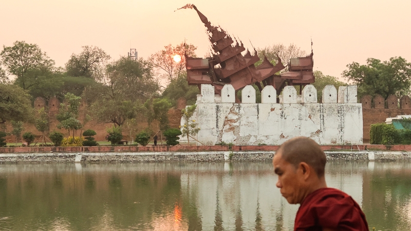 A Buddhist monk walks past the damaged Mandalay Palace in Myanmar three days after the deadly earthquake which killed at least 2,000 people