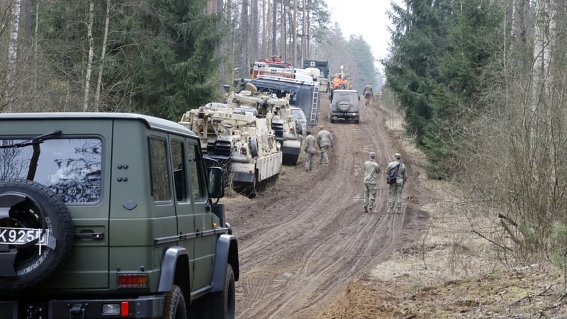 Military personnel work at the site of a rescue operation for missing US soldiers at Pabrade training ground, Lithuania