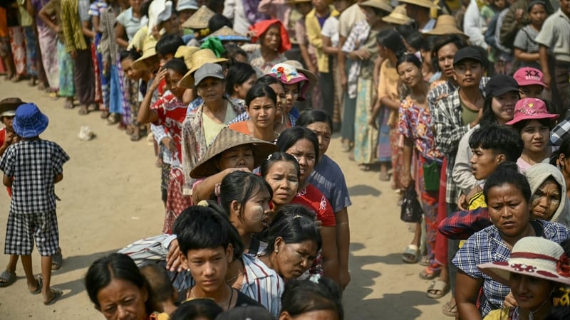 People queue for food being distributed in the city of Sagaing, Myanmar