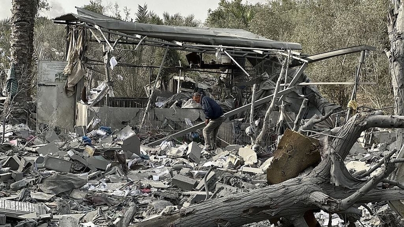 Civil defense teams carry out search and rescue operations in the rubble of a house in Khan Yunis
