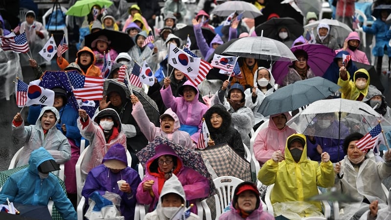 Supporters of impeached South Korean president Yoon Suk Yeol wave US and South Korean flags at a rally in Seoul