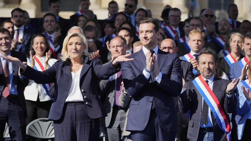 France's far-right leader Marine Le Pen and head of the National Rally party Jordan Bardella wave to the crowd
